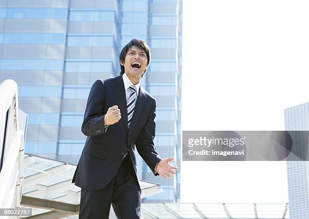 businessman with victory pose - 叫ぶ ストックフォトと画像