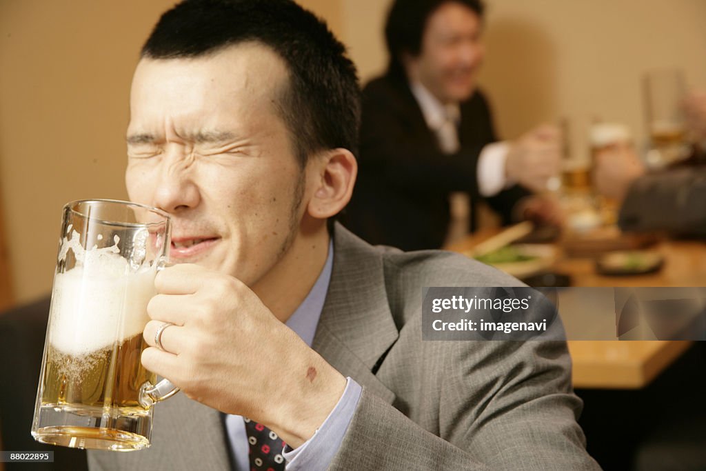 Man drinking beer in the Japanese-style pub