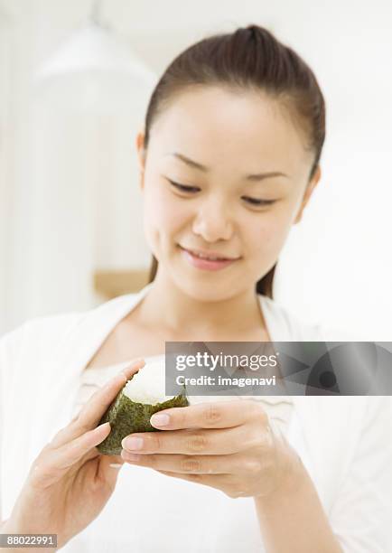 a woman making rice balls - woman smiling facing down stock pictures, royalty-free photos & images