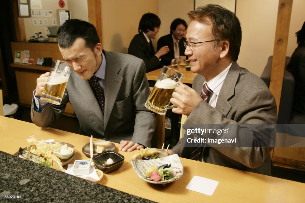 Man drinking beer in the Japanese-style pub