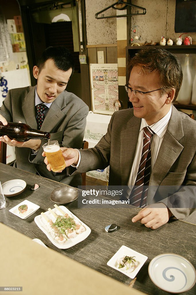 Men drinking beer in the Japanese-style pub