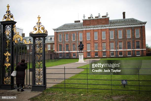 Woman takes a photo of Kensington Palace through the gates on November 24, 2017 in London, England. The American actress Meghan Markle will live at...