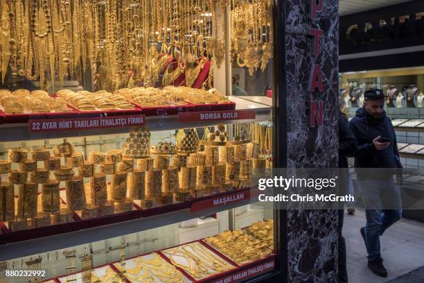 People walk past a gold store on November 27, 2017 in Istanbul, Turkey. The trial of Mr. Reza Zarrab an Iranian-Turk who ran a foreign exchange and...