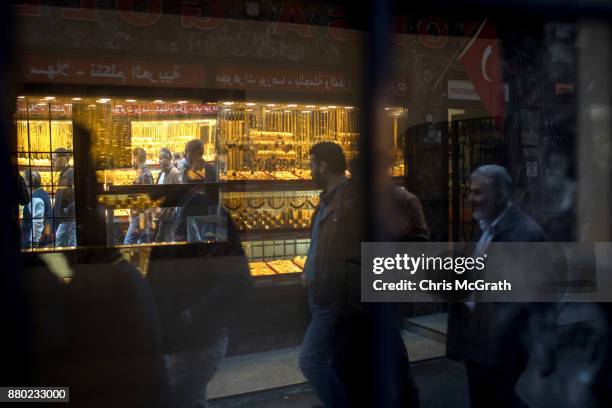 People walk past a gold store on November 27, 2017 in Istanbul, Turkey. The trial of Mr. Reza Zarrab an Iranian-Turk who ran a foreign exchange and...