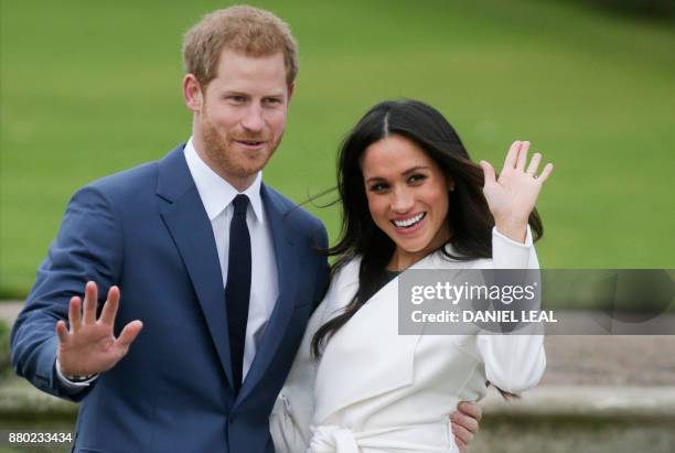 Britain's Prince Harry and his fiancée US actress Meghan Markle pose for a photograph in the Sunken Garden at Kensington Palace in west London on...