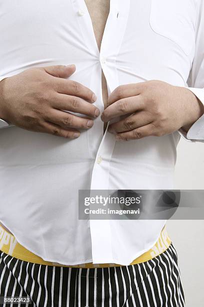 a man wearing a shirt - male belly button stock pictures, royalty-free photos & images