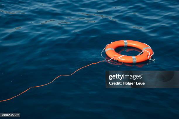 lifering with rope attached in adriatic sea, near hvar, split-dalmatia, croatia - cinturón salvavidas fotografías e imágenes de stock