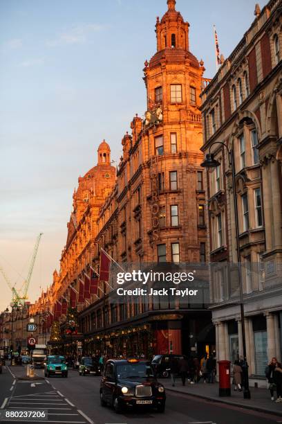 London Black Cab drives past the Harrods department store on Brompton Road on November 24, 2017 in London, England. The American actress Meghan...