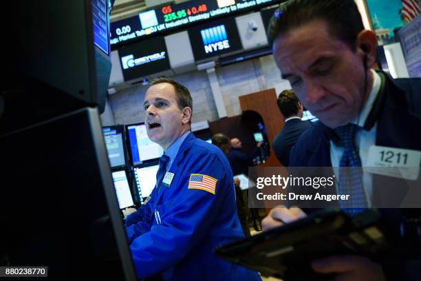 Traders work on the floor of the New York Stock Exchange at the opening bell, November 27, 2017 in New York City. Disney is marking the company's...