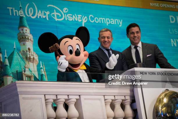 Mickey Mouse and Chief executive officer and chairman of The Walt Disney Company Bob Iger prepare to ring the opening bell at the New York Stock...