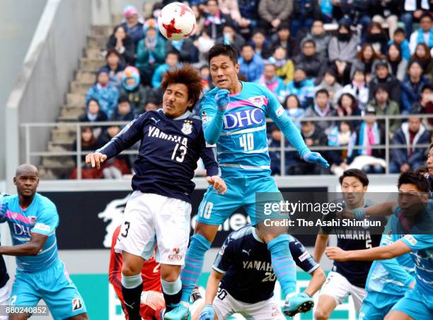 Yuji Ono of Sagan Tosu and Tomohiko Miyazaki of Jubilo Iwata compete for the ball during the J.League J1 match between Sagan Tosu and Jubilo Iwata at...