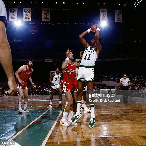 Charlie Scott of the Boston Celtics shoots against Rowland Garrett of the Chicago Bulls during a game played in 1975 at the Boston Garden in Boston,...
