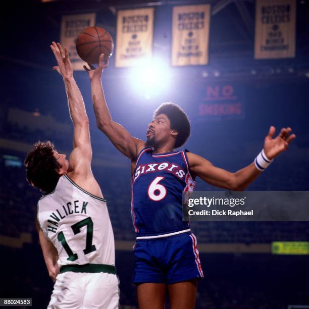 Julius Erving of the Philadelphia 76ers goes up for a shot against John Havlicek of the Boston Celtics during a game played in 1975 at the Boston...