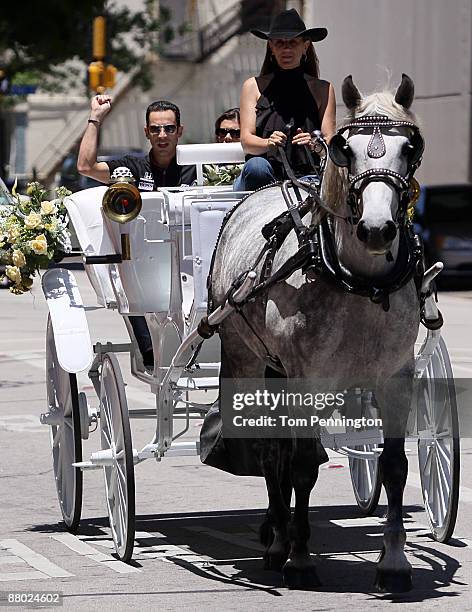 Helio Castroneves and Adriana Henao arrive at the Reata Resturant via a horse drawn carriage on May 27, 2009 in Fort Worth, Texas.