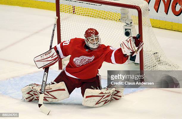Goalie Chris Osgood of the Detroit Red Wings makes a glove save in the first period against the Chicago Blackhawks during Game Five of the Western...