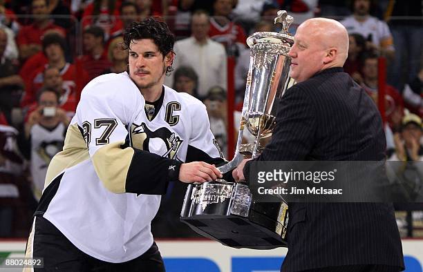 Sidney Crosby of the Pittsburgh Penguins accepts the Prince of Wales trophy from Deputy Commissioner of the NHL Bill Daly after their 4-1 win over...