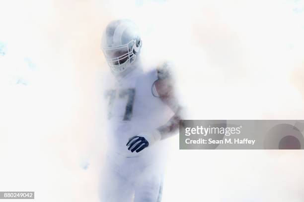 Andrew Whitworth of the Los Angeles Rams enters the field through smoke prior to a game against the New Orleans Saints at Los Angeles Memorial...