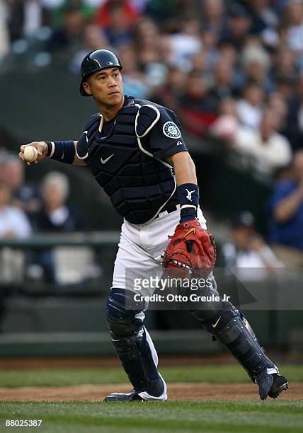 Catcher Kenji Johjima of the Seattle Mariners fields an infield ball during the game against the San Francisco Giants on May 22, 2009 in Seattle,...