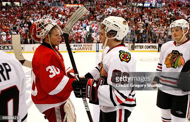 Goalie Chris Osgood of the Detroit Red Wings is congratulated by Patrick Kane of the Chicago Blackhawks after the Red Wings won 2-1 in overtime...