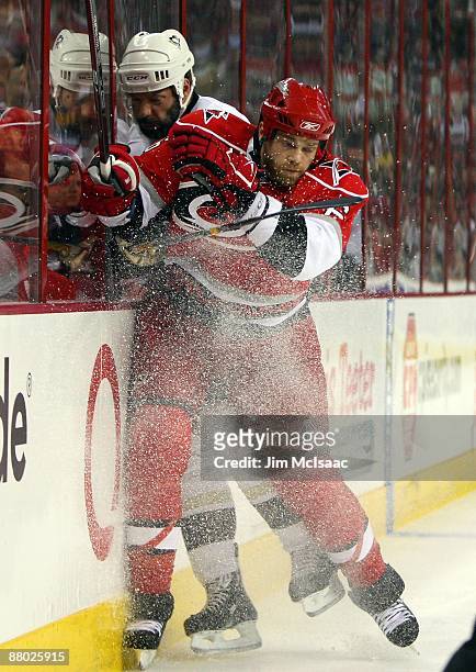 Tim Gleason of the Carolina Hurricanes checks Bill Guerin of the Pittsburgh Penguins during Game Four of the Eastern Conference Championship Round of...