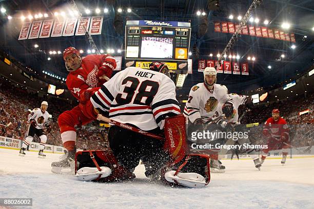 Chris Chelios of the Detroit Red Wings has his shot attempt stopped by Cristobal Huet of the Chicago Blackhawks during Game Five of the Western...