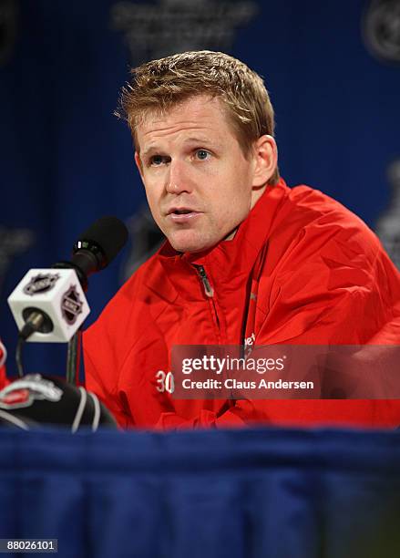 Goalie Chris Osgood of the Detroit Red Wings answers questions from the media at a press conference after their 2-1 overtime win against the Chicago...