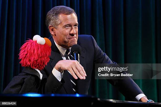 News Anchor Brian Williams appears onstage with Elmo at the 7th annual gala benefiting the Sesame Workshop at Cipriani 42nd Street on May 27, 2009 in...