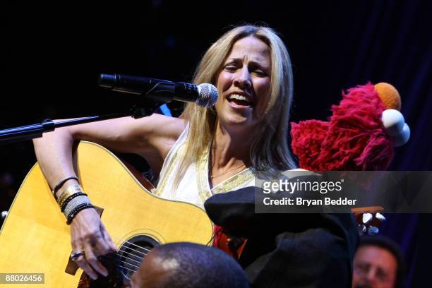 Musician Sheryl Crow performs with Elmo at the 7th annual gala benefiting the Sesame Workshop at Cipriani 42nd Street on May 27, 2009 in New York...