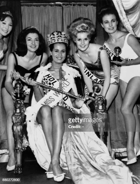 Catharina Lodders from Netherlands flanked by Miss France Monique Lemaire and Miss Finland Kaarina Leskinen reacts after being crowned Miss World...