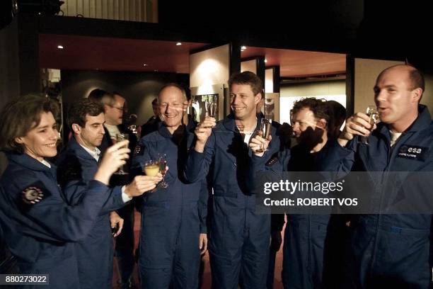 European Space Agency astronauts raise their glasses at the space exhibition in Noordwijk, 20 December 2000. The astronauts gather in Noordwijk to...