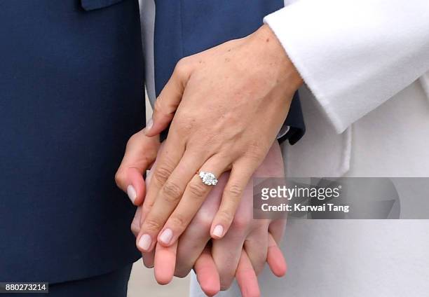 Prince Harry and Meghan Markle, ring detail, attend an official photocall to announce the engagement of Prince Harry and actress Meghan Markle at The...