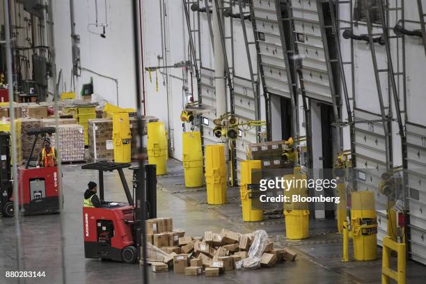 An employee operates a forklift to move boxes at the Amazon.com Inc. Fulfillment center in Robbinsville, New Jersey, U.S., on Monday, Nov. 27, 2017....