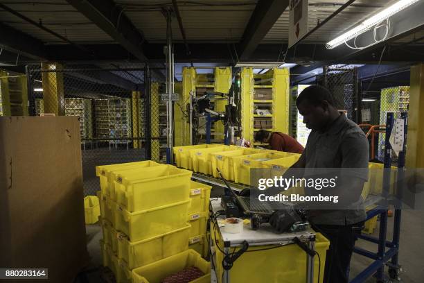 Employees fill online orders at the Amazon.com Inc. Fulfillment center in Robbinsville, New Jersey, U.S., on Monday, Nov. 27, 2017. The holiday...