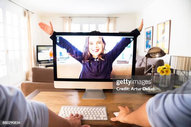 creative picture of a guy working from home with personal perspective with kid playing behind the screen computer with transparency and playing with perspective in a original idea. - crazy dad stock pictures, royalty-free photos & images