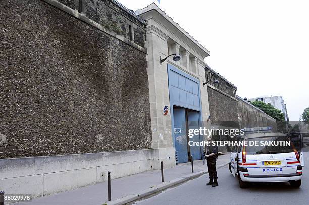 French policeman stands guard in front of the Sante Prison in Paris, on May 28 prior to the release of French Julien Coupat, suspected of being the...