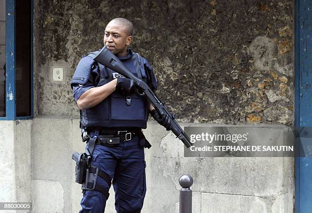 French policeman stands guard in front of the Sante Prison in Paris, on May 28 prior to the release of French Julien Coupat, suspected of being the...