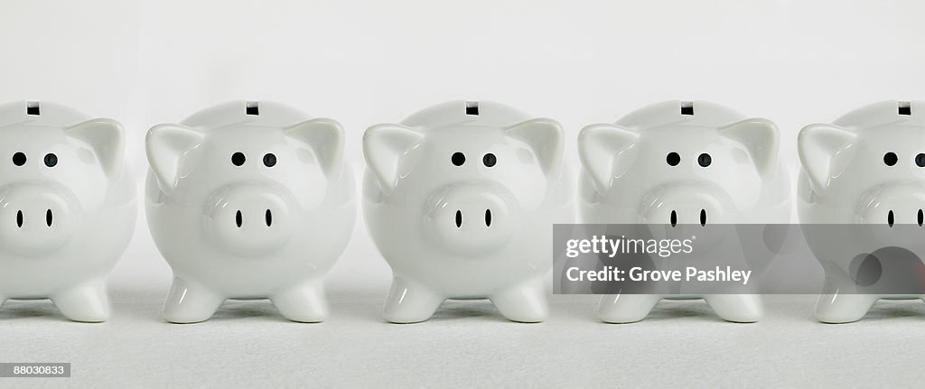 Row of white piggy banks