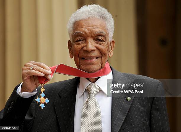 Actor Earl Cameron poses outside Buckingham Palace with his CBE, presented by the Prince of Wales on May 28, 2009 in London, England.