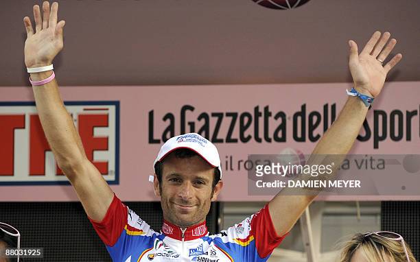 Italy's Michele Scarponi celebrates on the winner stand after he carried off the eightteenth stage of 92nd Giro of Italy between Sulmona and...