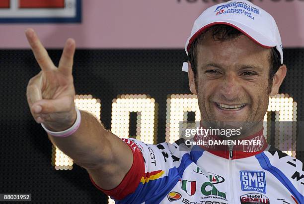 Italy's Michele Scarponi celebrates on the podium after winnning the 18th stage of 92nd Giro of Italy between Sulmona and Benevento on May 28, 2009....