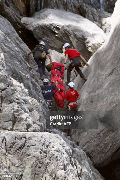 Rescuers carry the body of a six-year-old German girl less than 24 hours after she was reported missing, at the foot of a cliff, near Ermita de Sant...