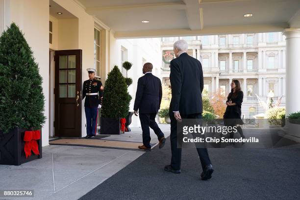 Senate Finance Committee Chairman Orrin Hatch and Sen. Tim Scott walk back into the West Wing after talking with reporters following a lunch meeting...