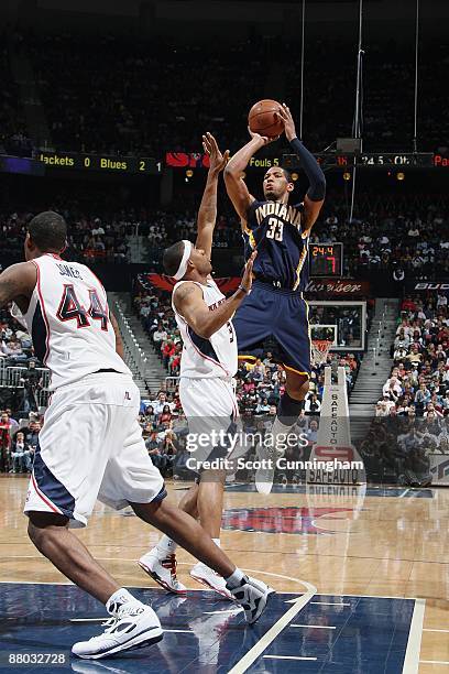 Danny Granger of the Indiana Pacers shoots the ball over Thomas Gardner of the Atlanta Hawks during the game on April 10, 2009 at Philips Arena in...