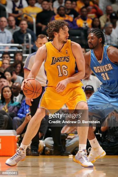 Pau Gasol of the Los Angeles Lakers looks to maneuver against Nene of the Denver Nuggets in Game Two of the Western Conference Finals during the 2009...