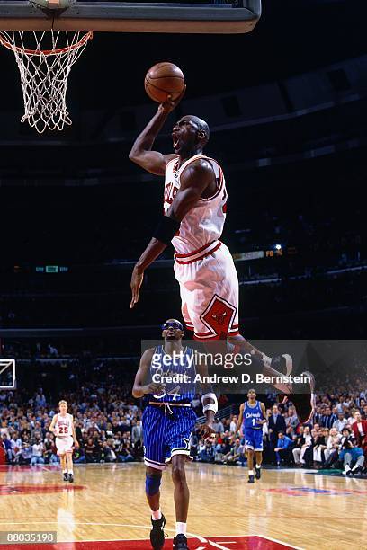 Michael Jordan of the Chicago Bulls dunks against Horace Grant of the Orlando Magic in Game Six of the Eastern Conference Semifinals during the 1995...
