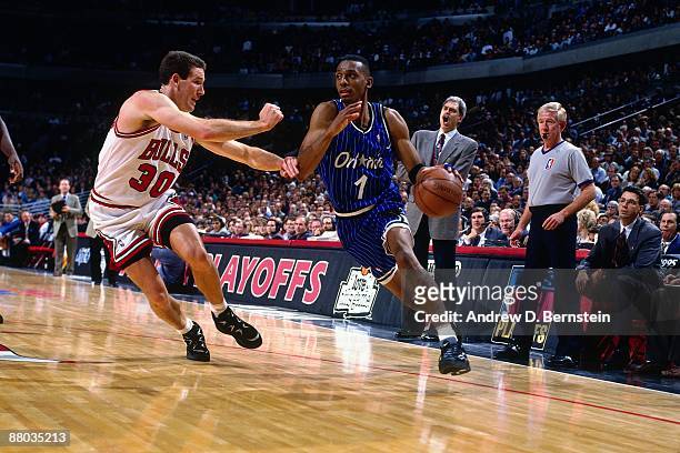 Anfernee Hardaway of the Orlando Magic drives to the basket against Jud Buechler of the Chicago Bulls in Game Six of the Eastern Conference...