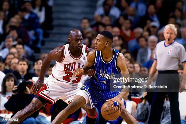 Anfernee Hardaway of the Orlando Magic moves the ball against Michael Jordan of the Chicago Bulls in Game Six of the Eastern Conference Semifinals...