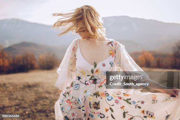 beautiful hippie woman dancing in a meadow - autumn czech republic stock pictures, royalty-free photos & images