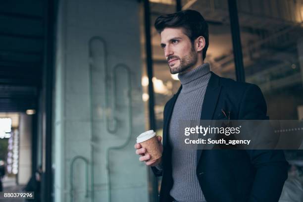 hermoso empresario barbudo con un café - cuello alto fotografías e imágenes de stock