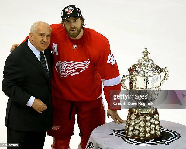 Jim Gregory the Sr. Vice President of hockey operations presents Henrik Zetterberg of the Detroit Red Wings the Clarence S. Campbell Bowl after Game...